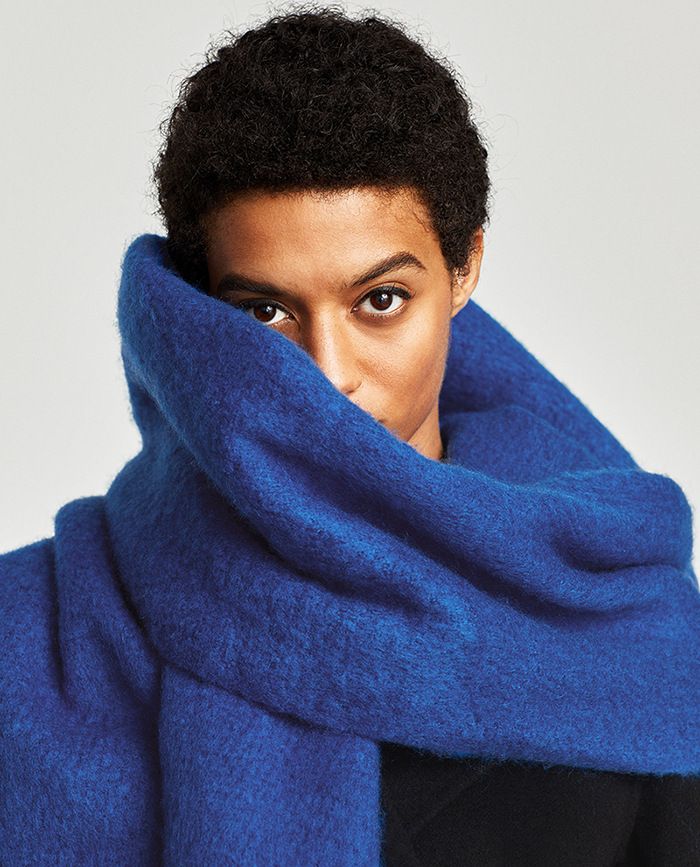 The beauty of a caramel-colored down jacket paired with a scarf